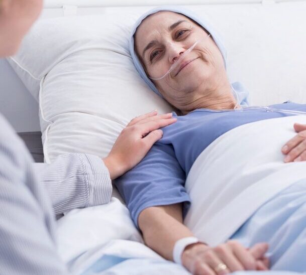 palliative image - woman in bed being cared for by nurse