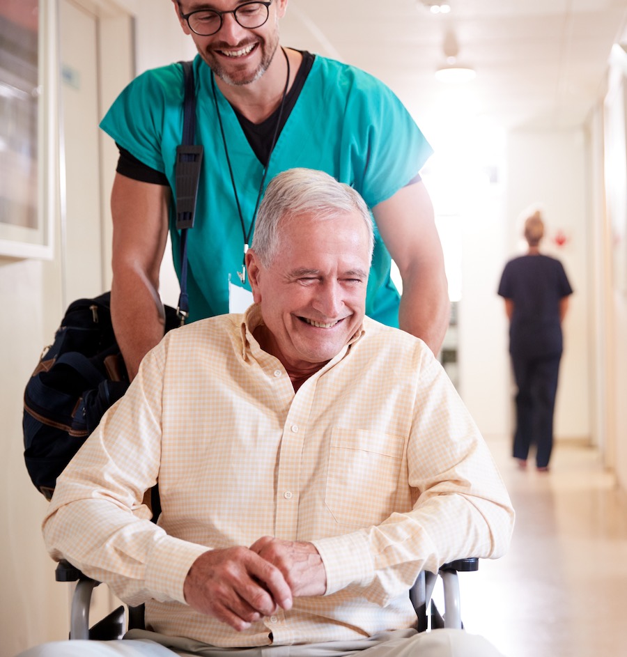 A man being discharged from hospital in a wheelchair